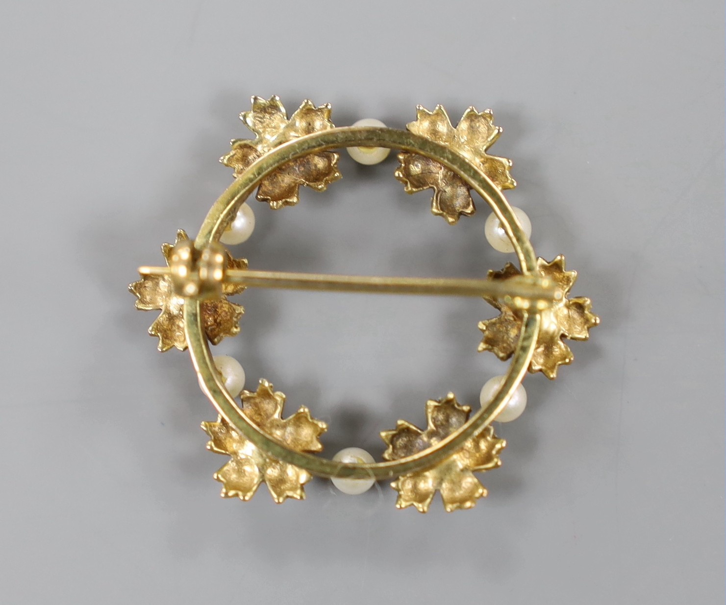 A modern 9ct gold, diamond and seed pearl set circular open work brooch, 28mm, gross weight 3.5 grams.